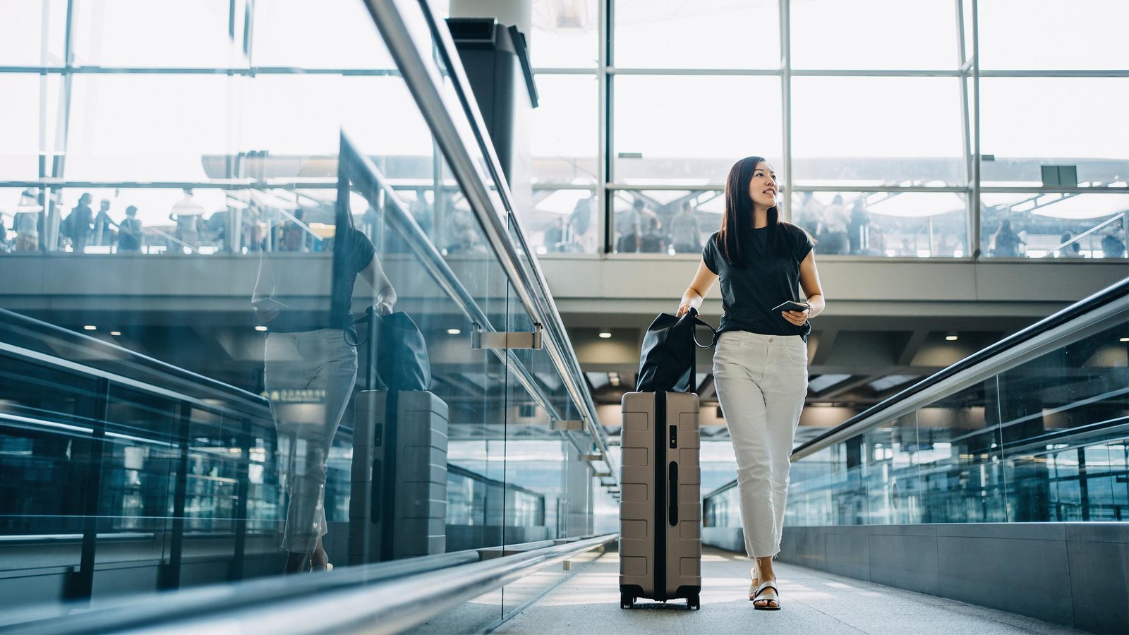 Premium suitcase standing in a bright airport terminal